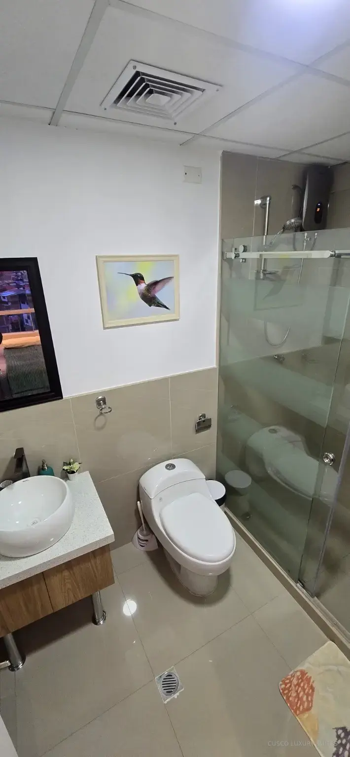 Modern full bathroom with glass shower in AYLLU SUITE