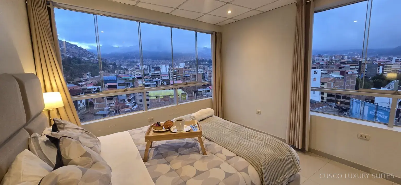 AYLLU SUITE second bedroom with corner windows and city views