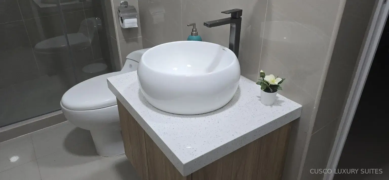 Modern vanity and glass shower detail in the INTI SUITE bathroom