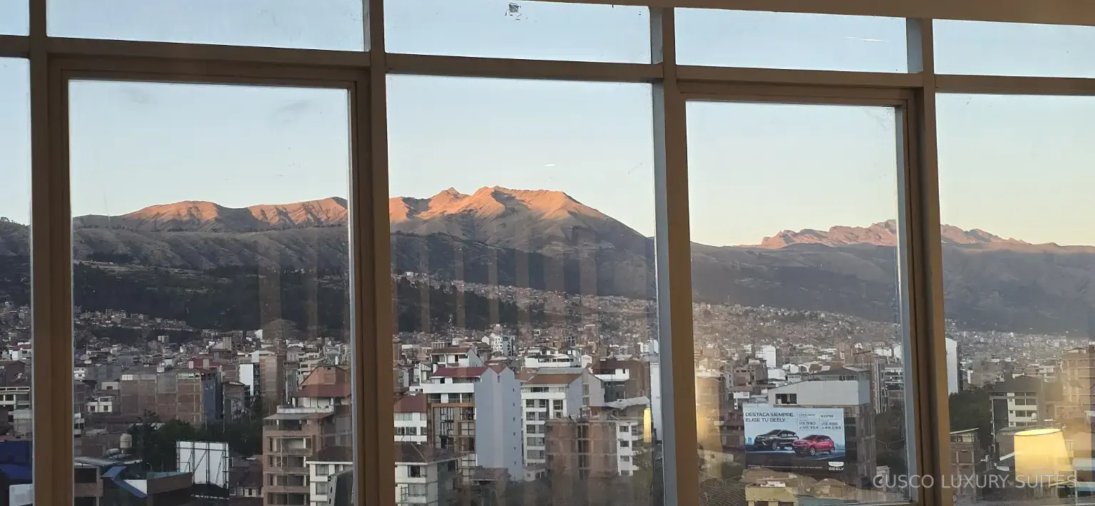 Sunset light across the mountains and Cusco skyline from INTI SUITE