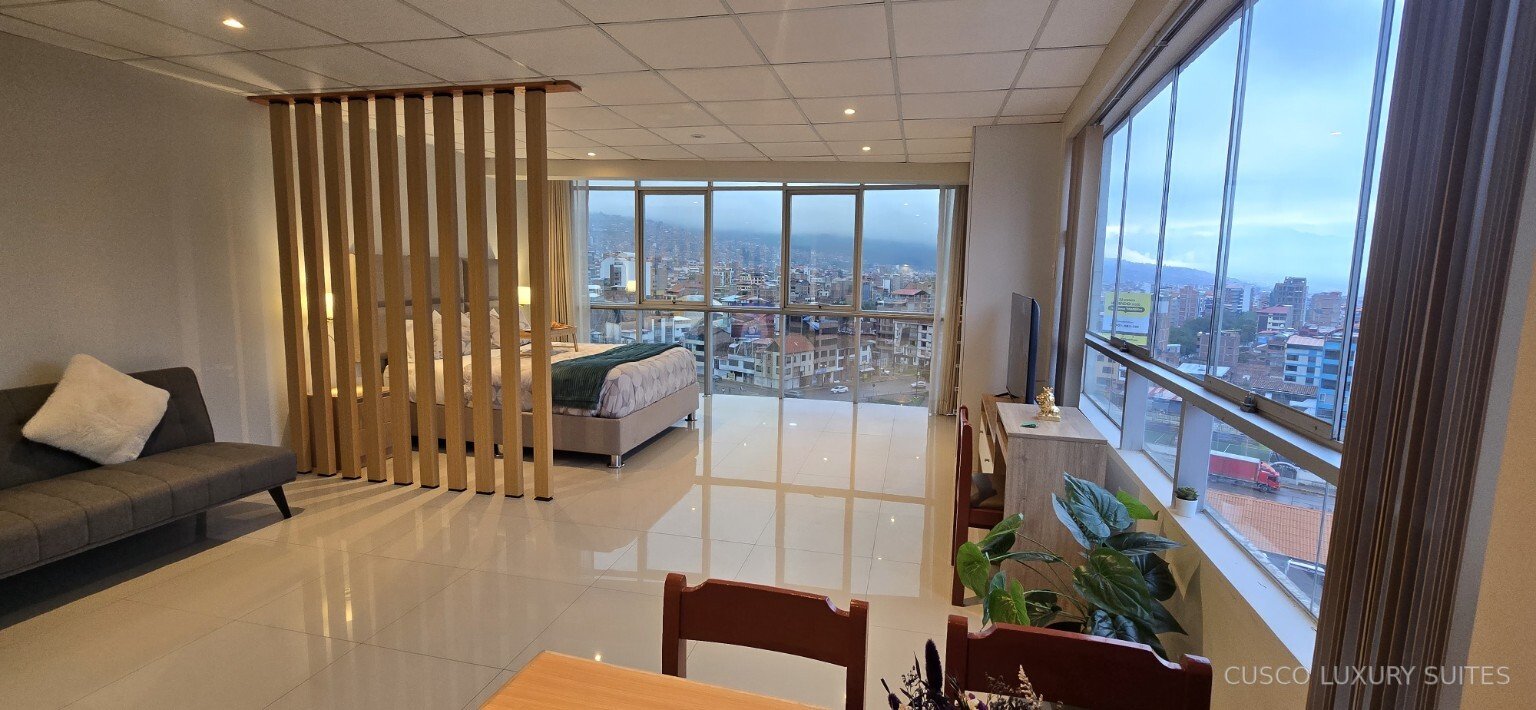 SUMAQ SUITE living and dining space with city views on two sides