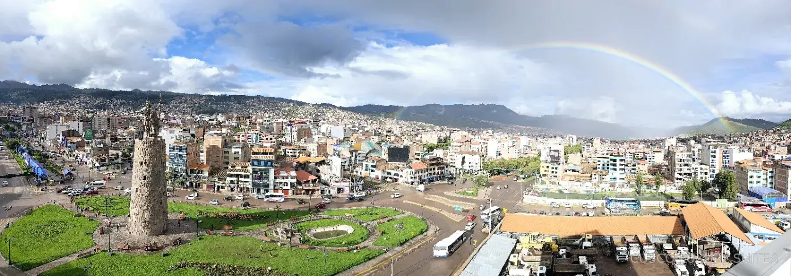 Panoramic view of Cusco, the Pachacútec Monument and a rainbow from SUMAQ SUITE