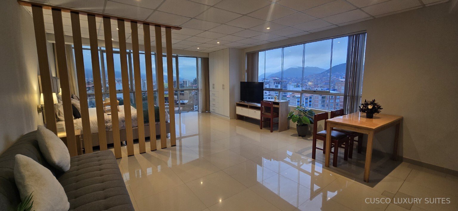 SUMAQ SUITE living and dining room at twilight with panoramic mountain views